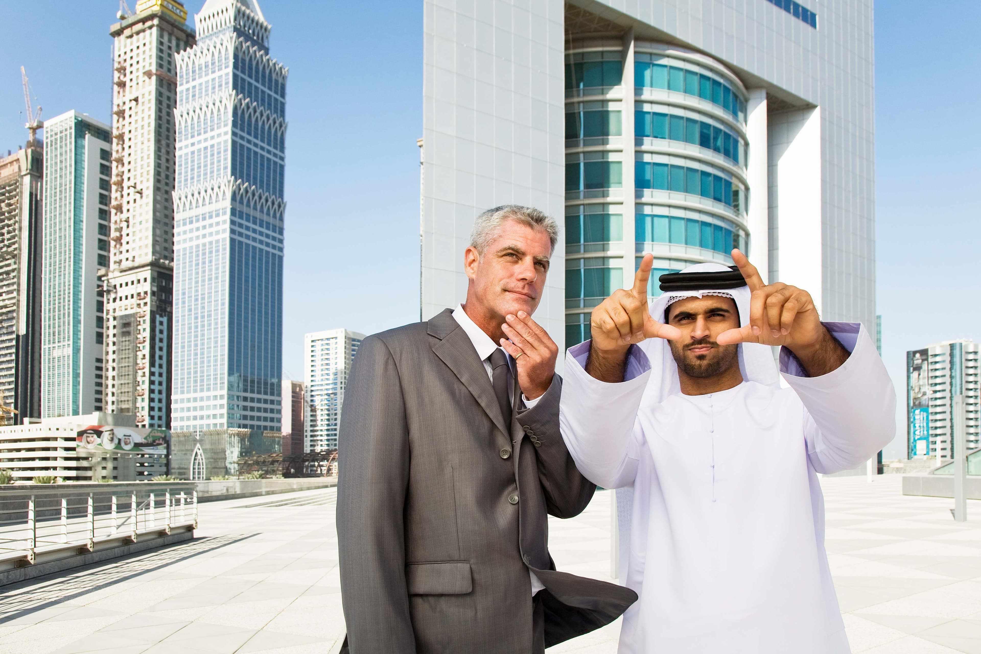 A professional using a tablet to interact with an AI real estate assistant, with Dubai's landmarks in the background